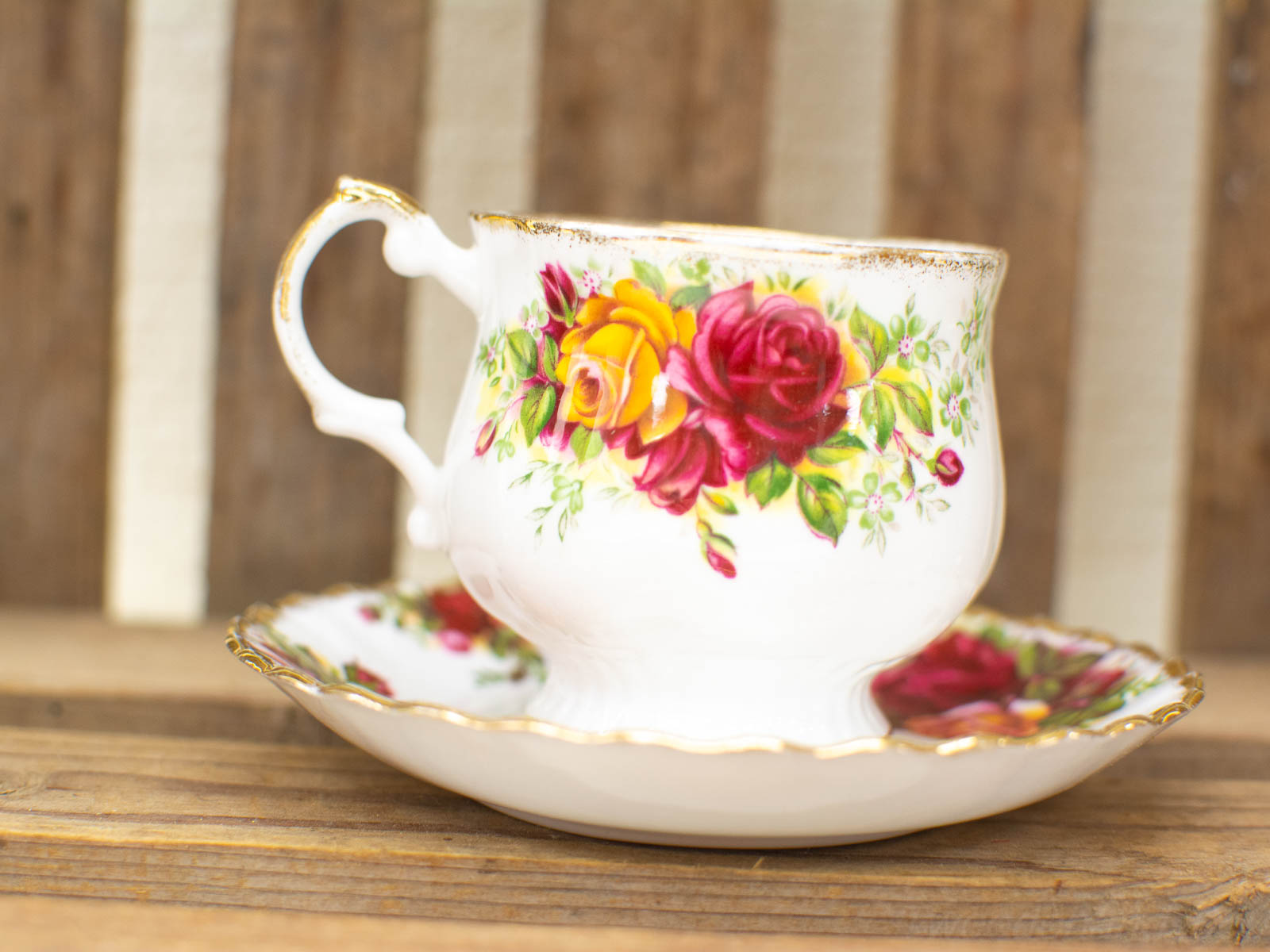 Elegant vintage porcelain teacup and saucer with floral design, perfect for a charming tea experience.