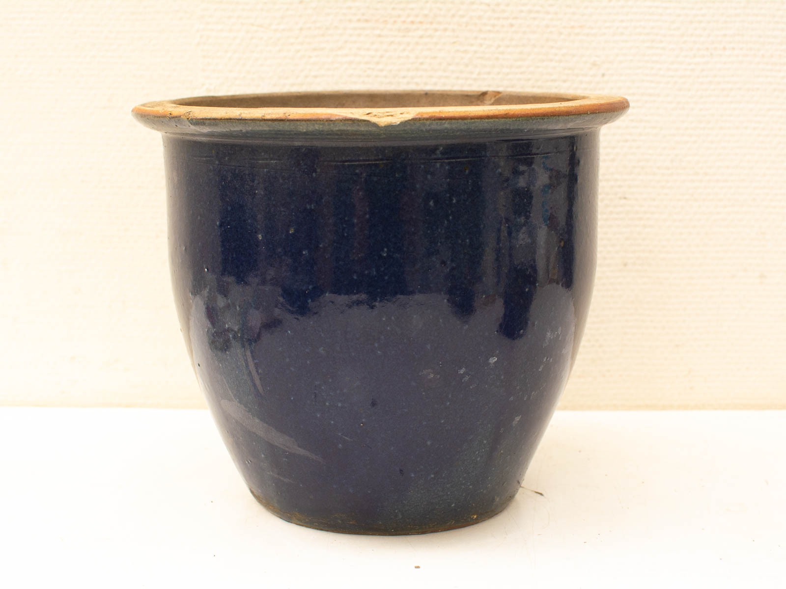 Vintage blue ceramic pot with terracotta band, perfect for plants or decorative display.