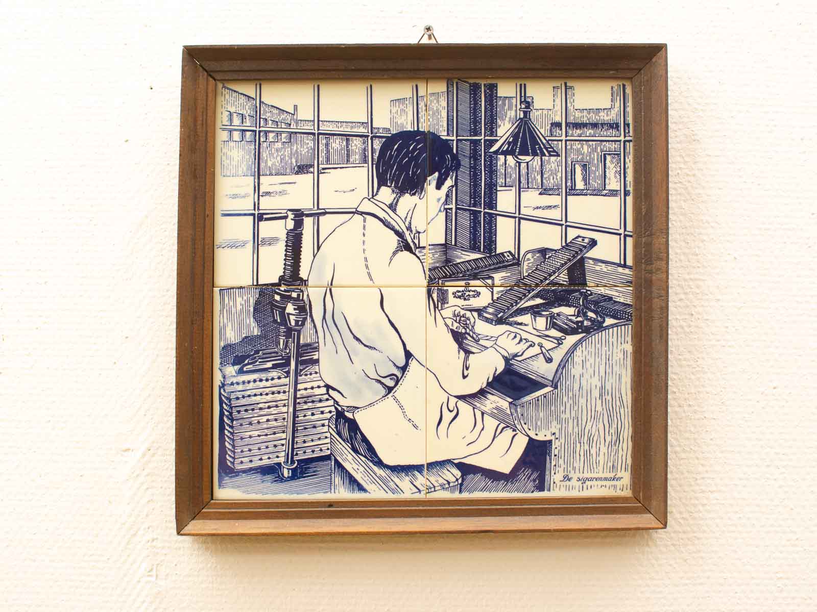 Delft blue artwork showcasing a craftsman at work, celebrating traditional craftsmanship and artistry.