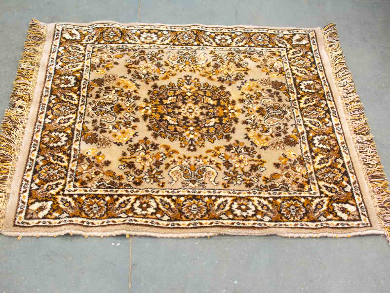 Elegant vintage beige carpet with intricate floral designs, perfect for enhancing home decor.