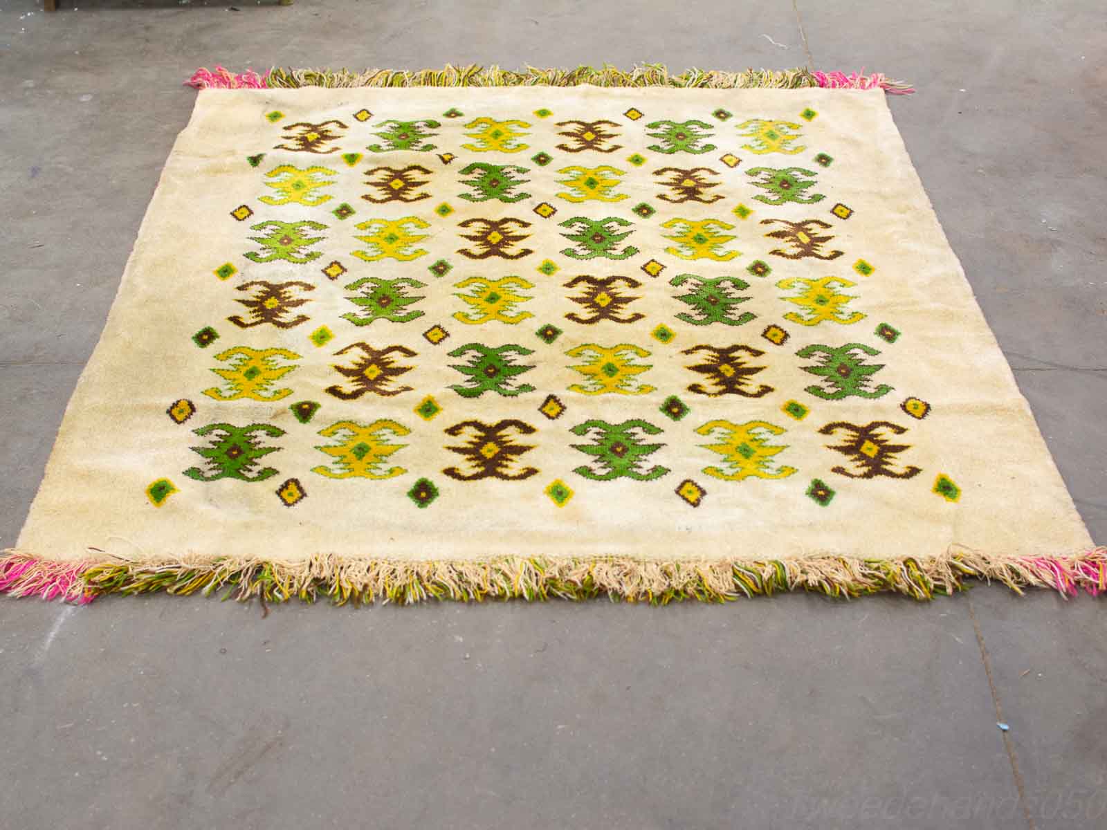 Vibrant vintage geometric rug with fringes, perfect for adding warmth and style to any room.