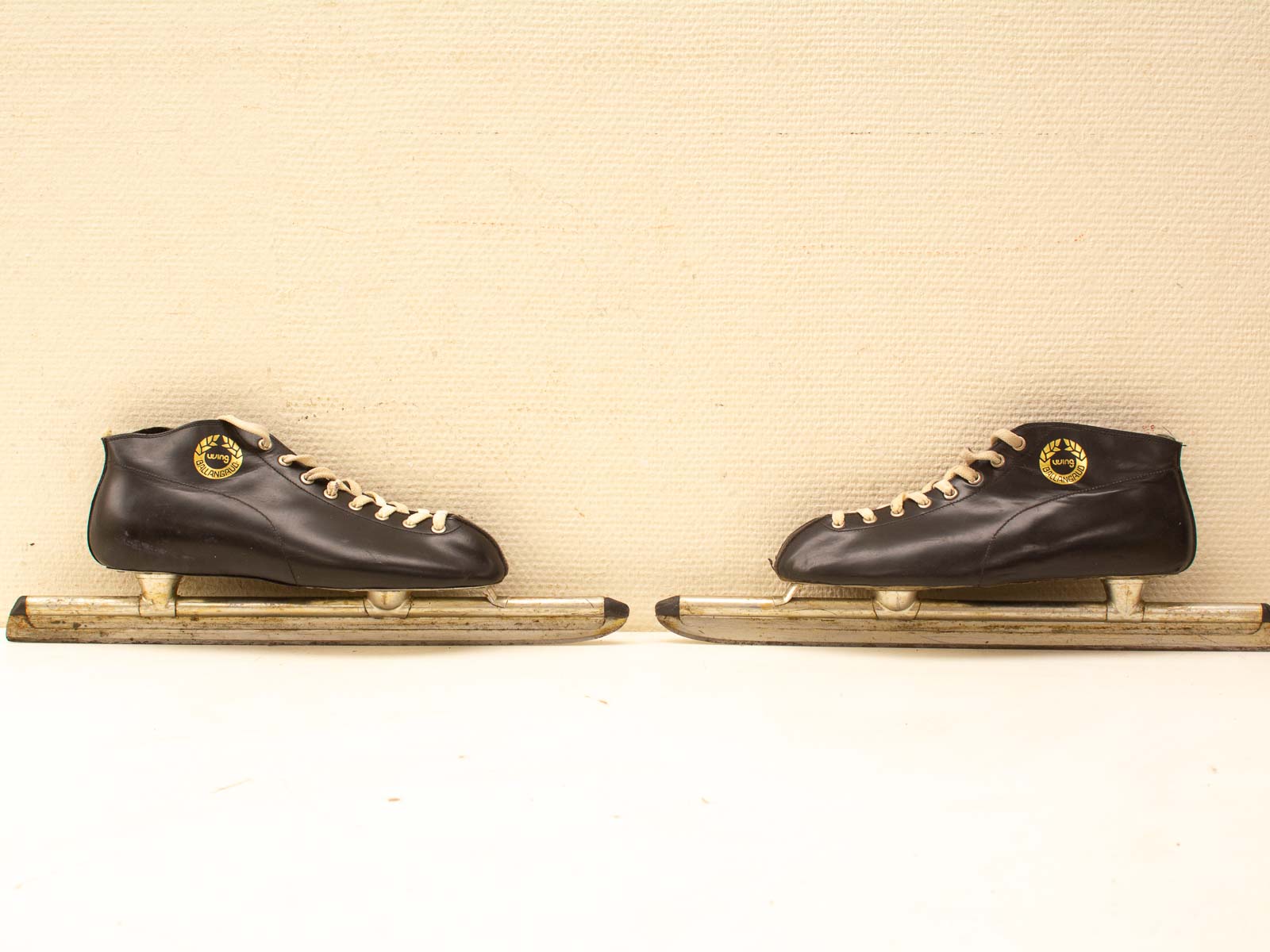 Classic vintage black leather ice skates with beige laces, perfect for winter sports enthusiasts.