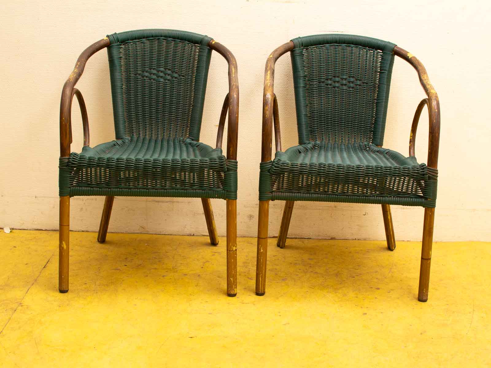 Vintage wooden chairs with green weaving, adding retro charm to any space.