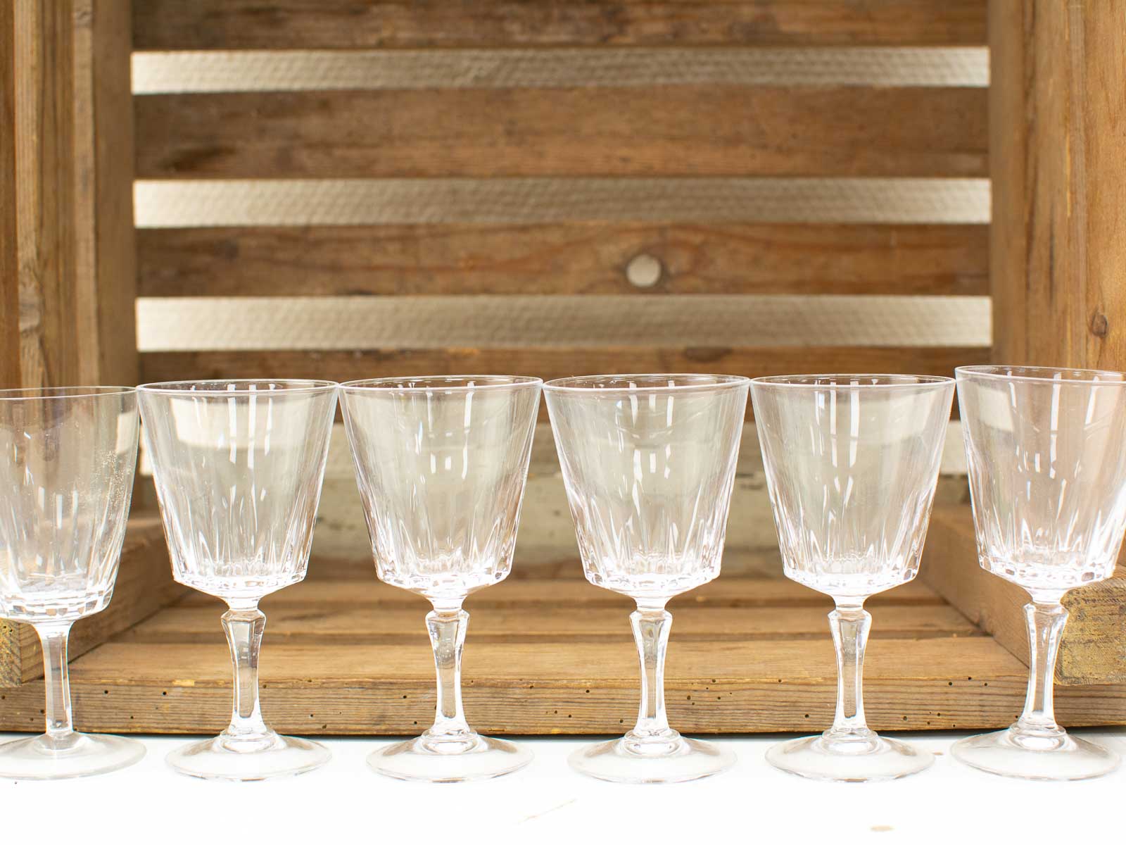 Elegant glassware set on rustic wooden crate, perfect for any occasion and stylish entertaining.