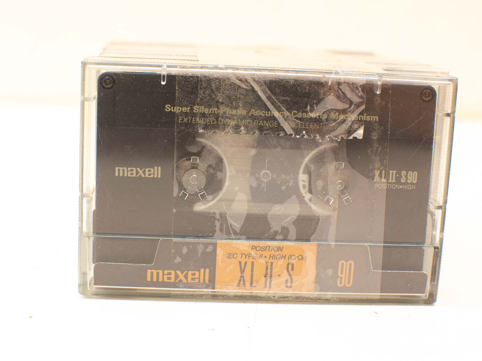 Vintage Maxell cassette tape in clear case, 90-minute capacity, perfect for audio enthusiasts.