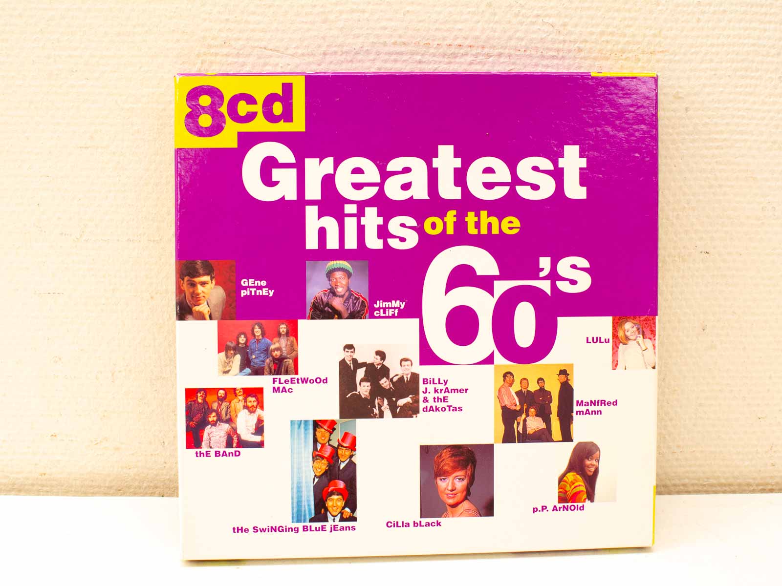 1960s Greatest Hits album cover featuring iconic artists in vibrant purple and yellow design.