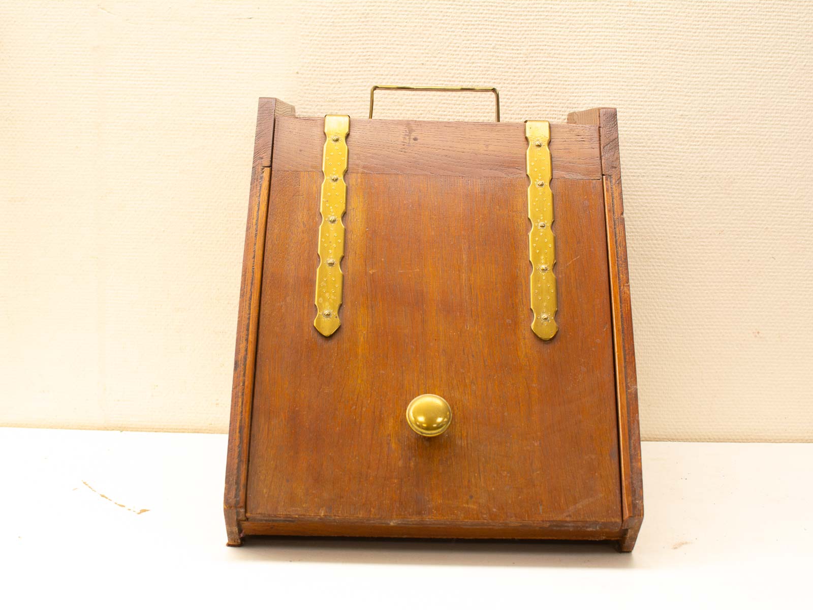 Antique wooden box with brass knob, elegant design, perfect for storage or decor.