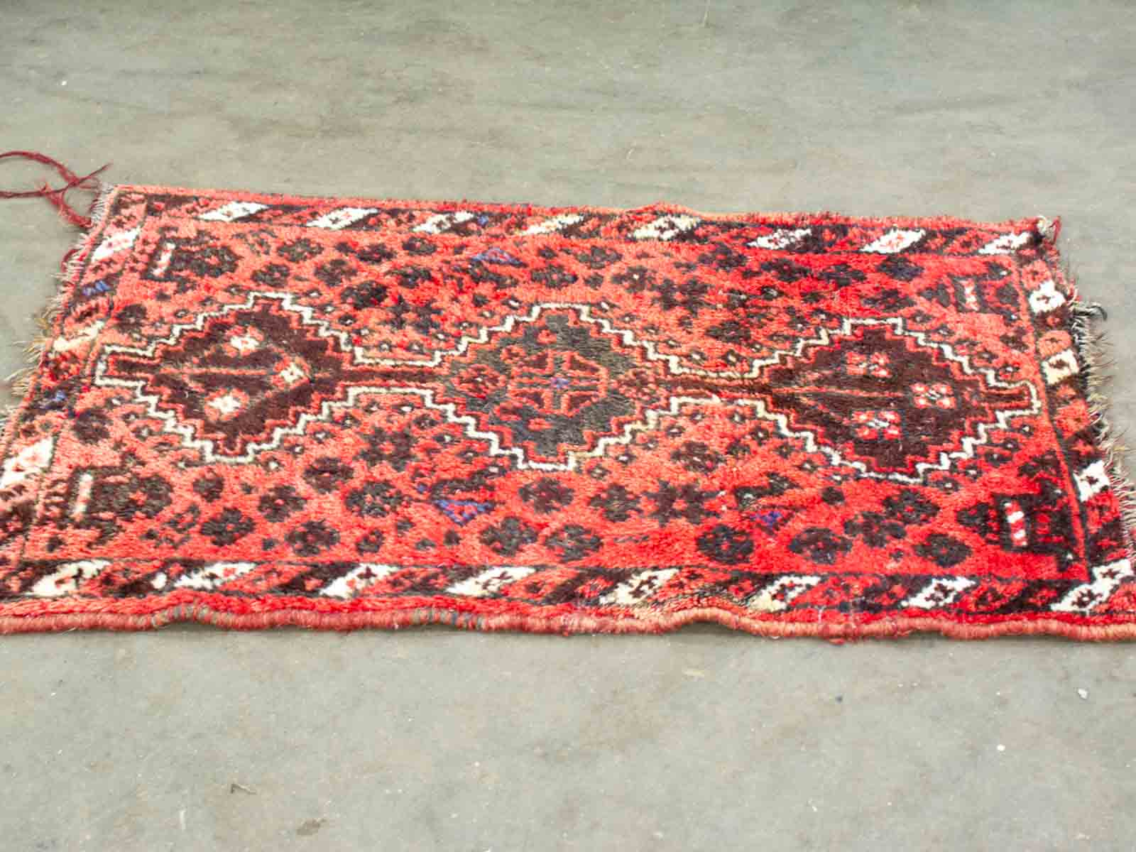 Vibrant vintage geometric rug with rich colors and intricate patterns, perfect for traditional decor.