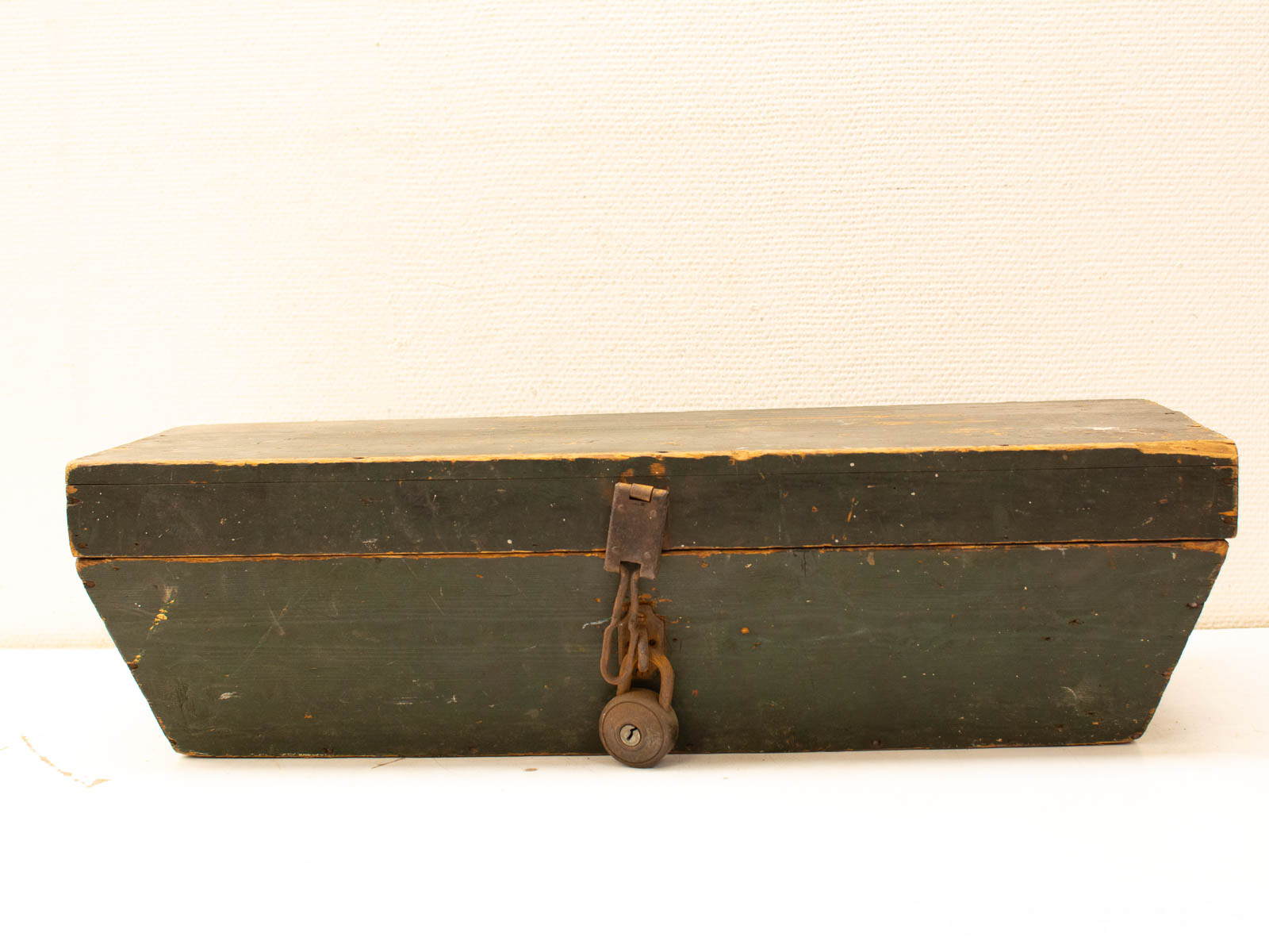 Antique wooden box with rustic green finish and vintage metal latch, perfect for storage.