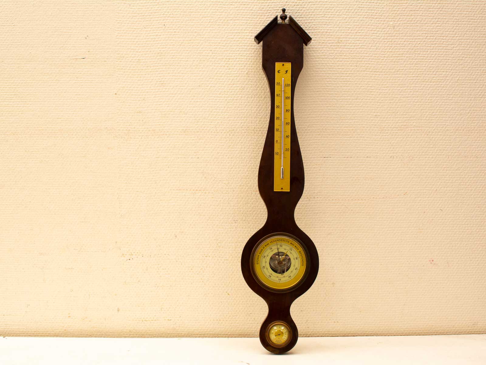 Elegant antique wooden barometer and thermometer, combining vintage charm with functional design.