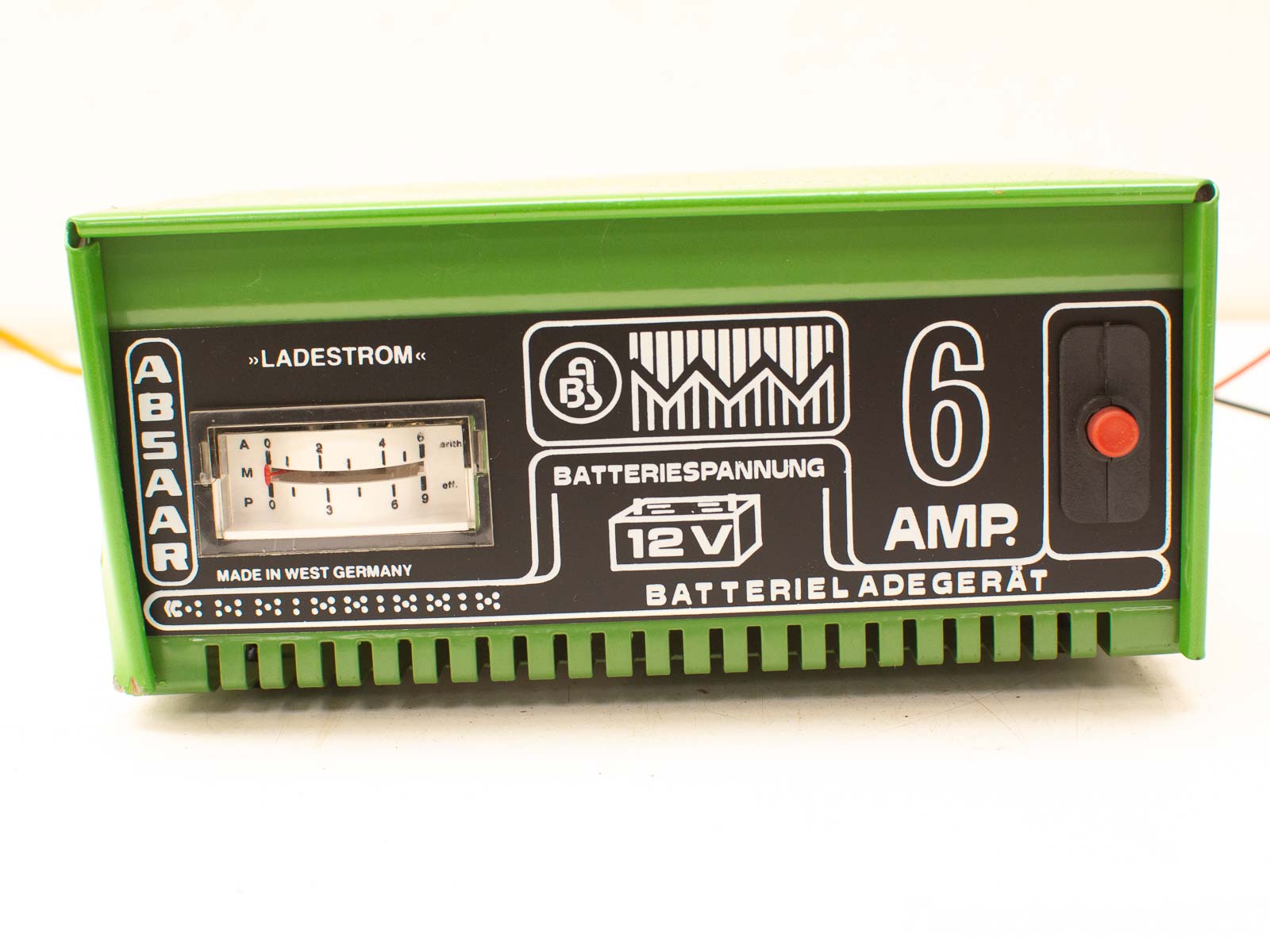 Classic green 12V ABSAAR battery charger with meter, power button, and ventilation slots.