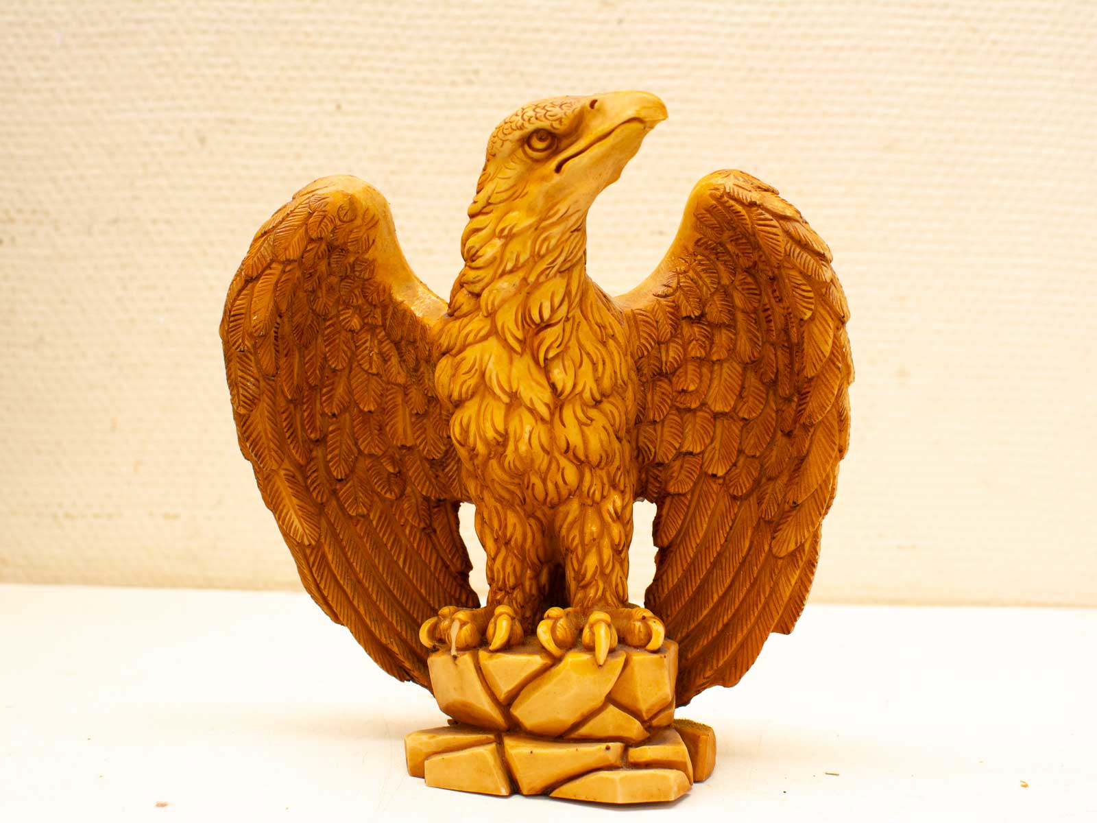 Golden eagle sculpture with detailed feathers, embodying strength and freedom.