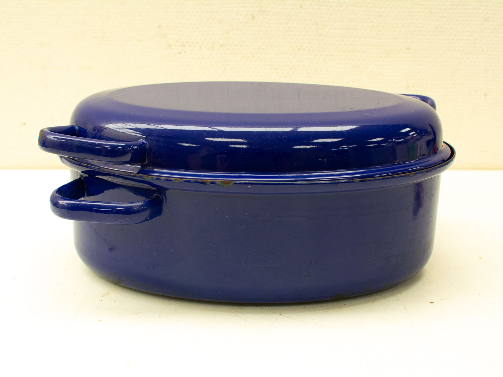 Vintage deep blue enamel cookware, ideal for family meals and versatile cooking methods.