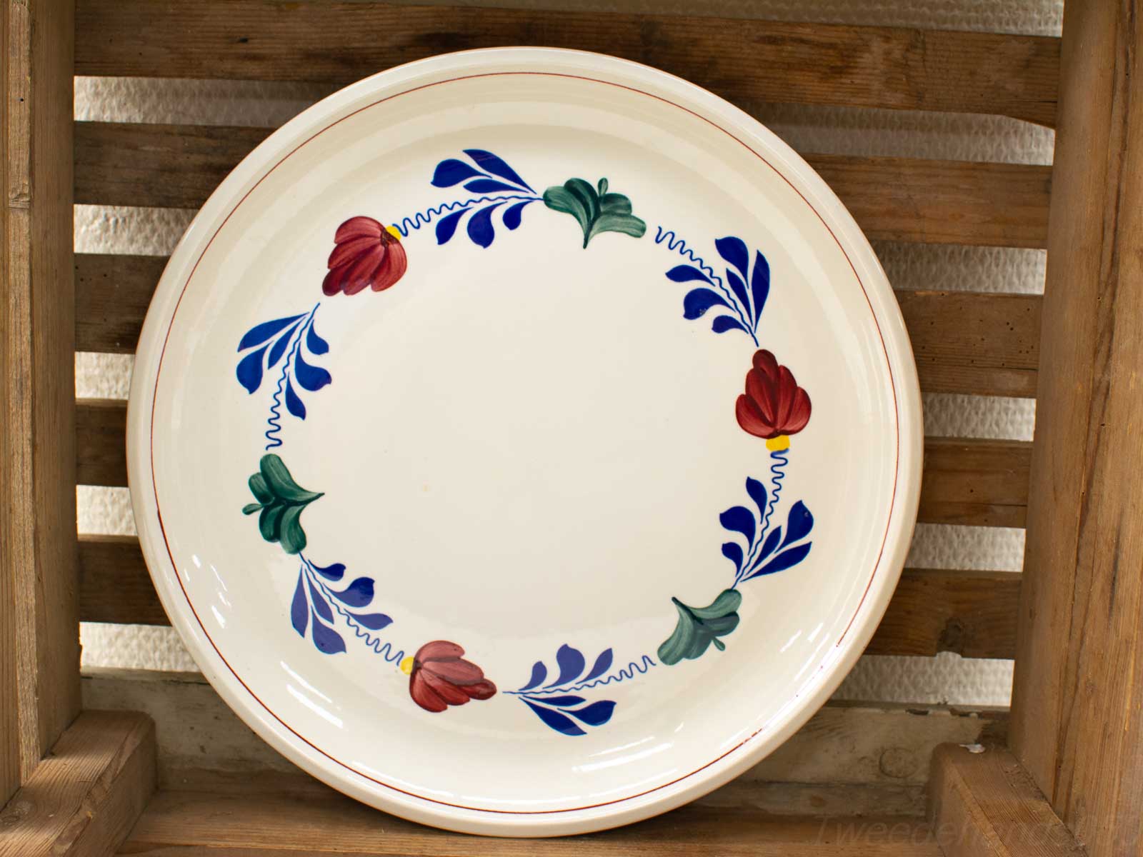 Vibrant floral ceramic plate with elegant tulip design and sophisticated red rim.