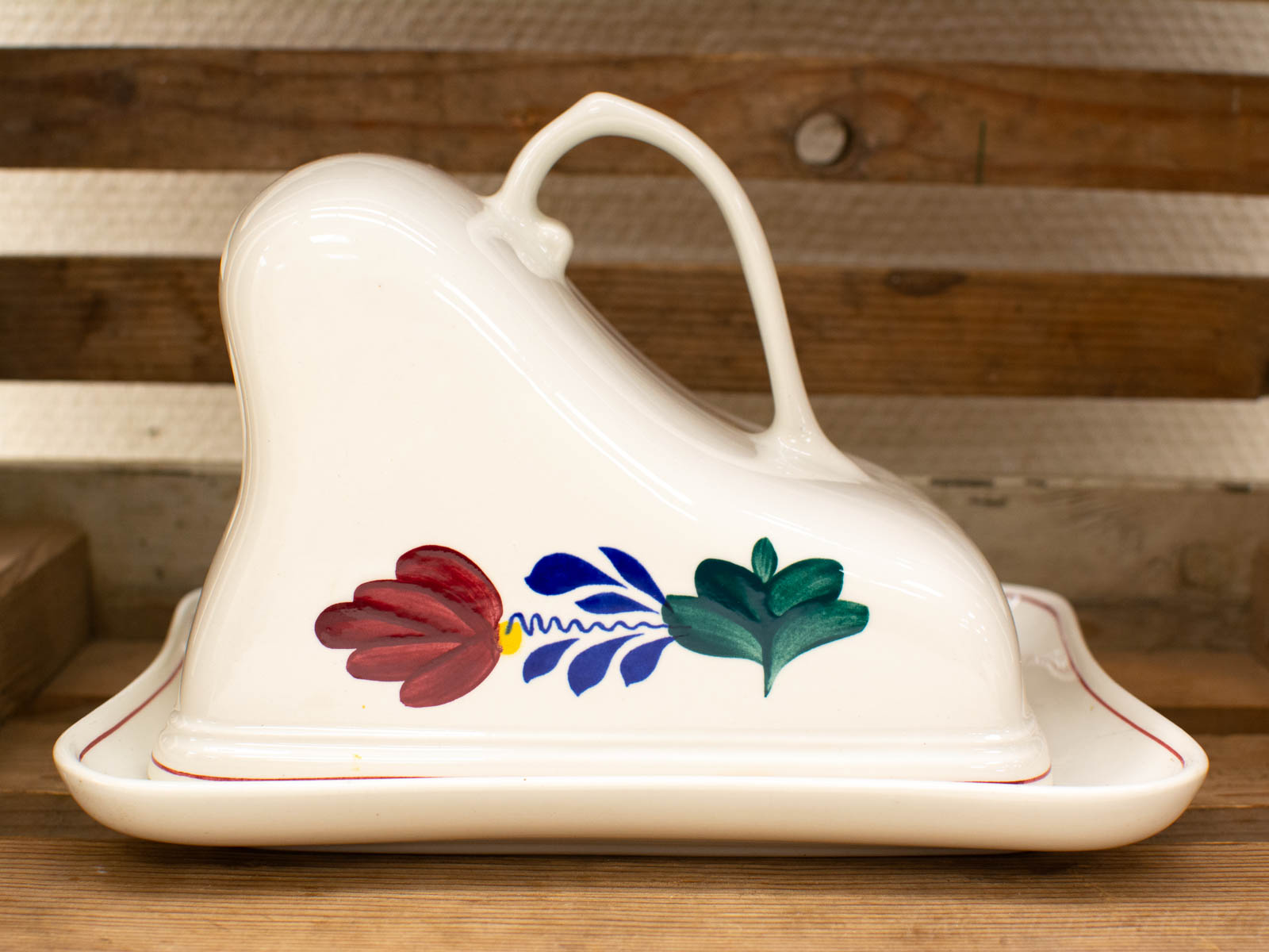 Charming vintage ceramic butter dish with vibrant floral designs, perfect for collectors and decor.