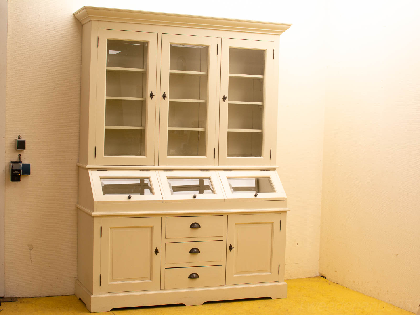 Elegant white cabinet with glass doors, spacious storage, and functional workspace for versatile home decor.