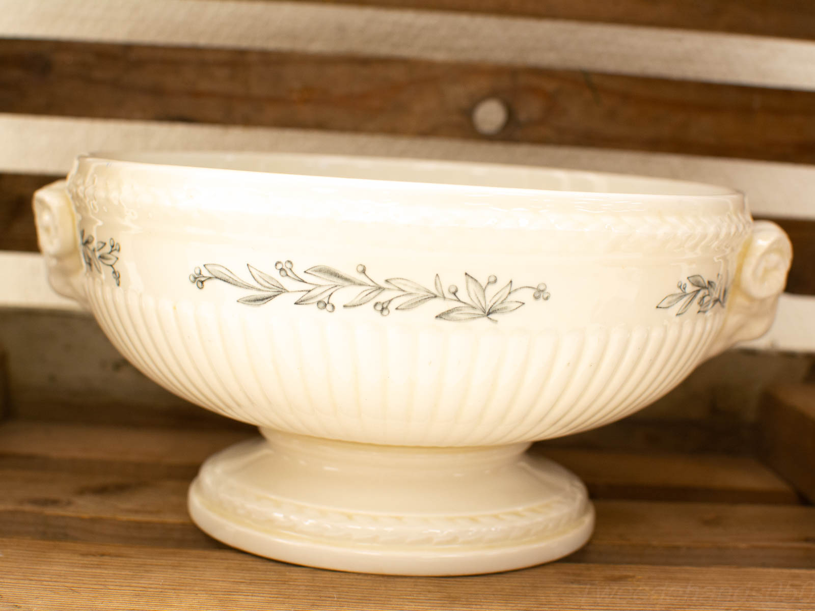 Elegant vintage ceramic bowl with floral design and sculpted leaf handles for home decor.