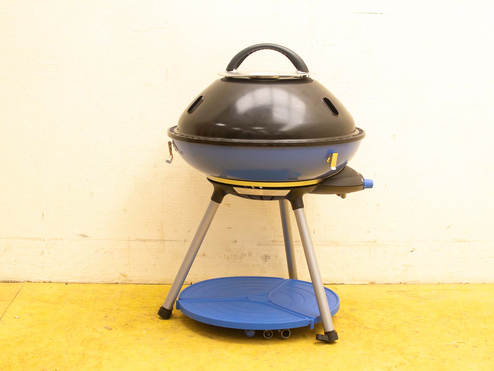 Sleek black and blue charcoal grill, perfect for stylish outdoor cooking and gatherings.