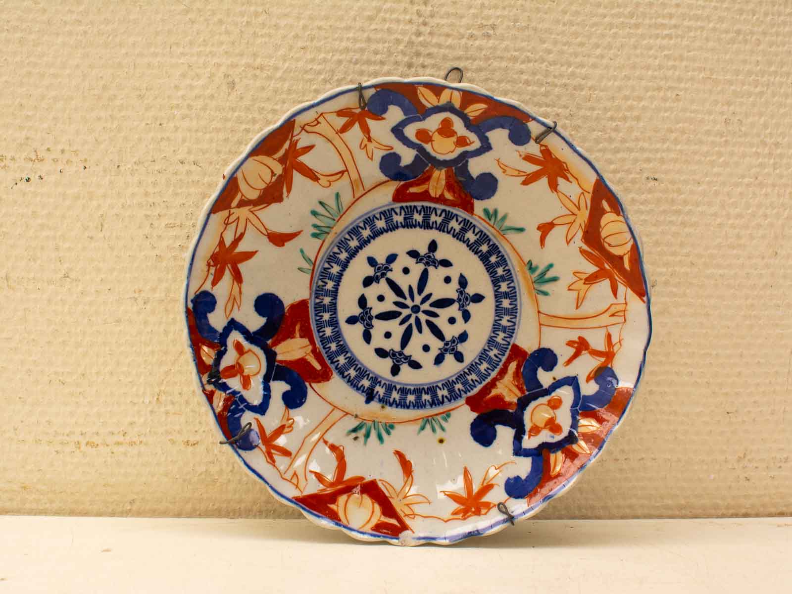 Elegant decorative plate with vibrant blue and orange patterns, perfect for display or serving.