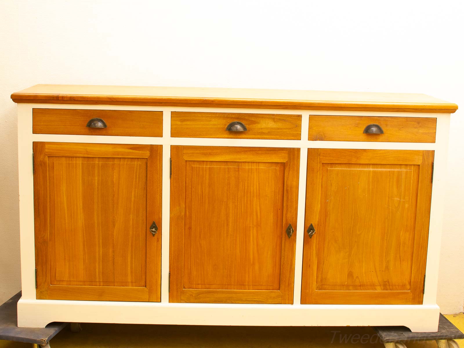 Elegant wooden sideboard with diamond-shaped keyhole and dark metal handles, perfect for versatile home decor.