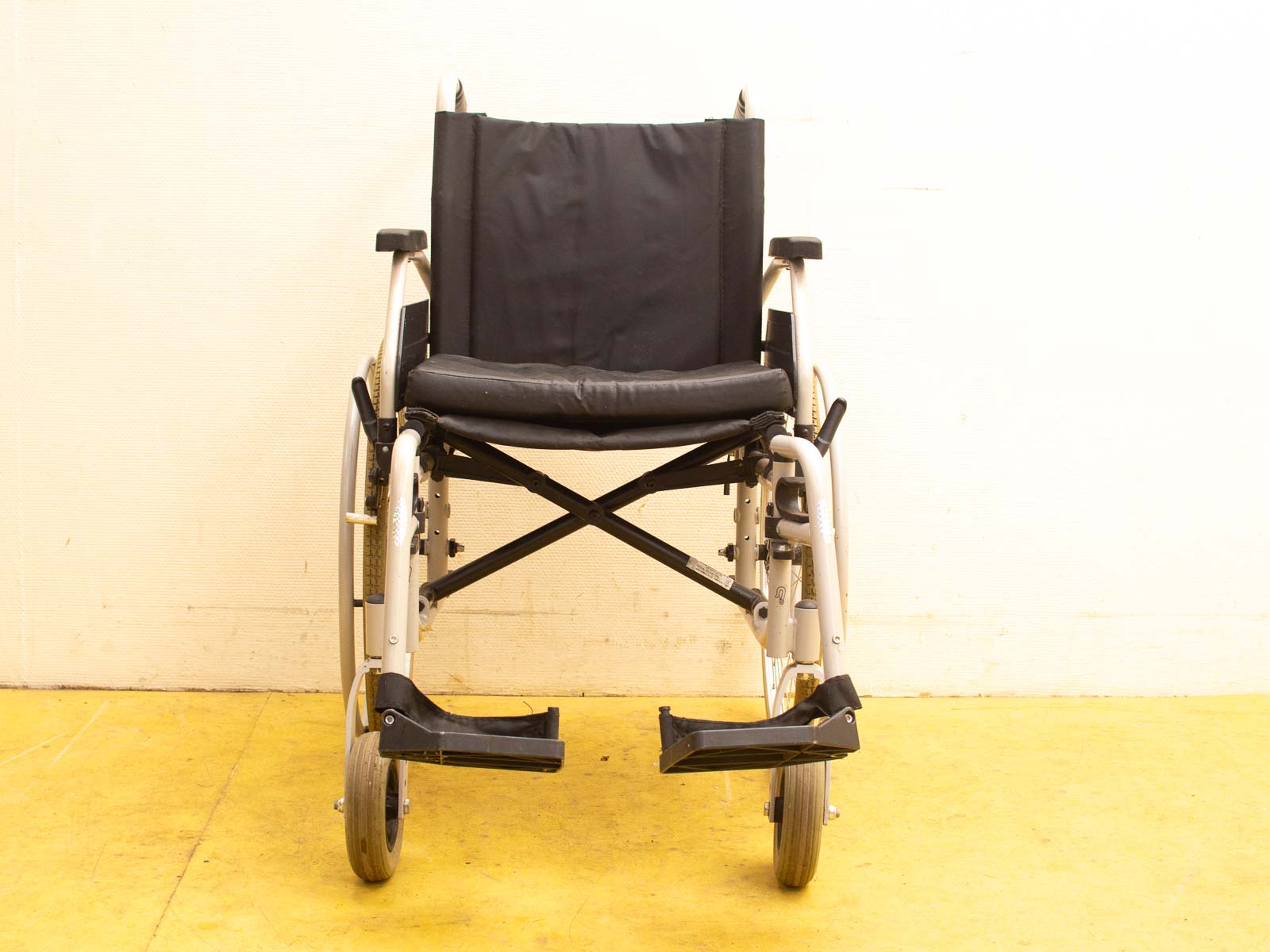 Sleek black wheelchair with comfortable footrests and durable fabric seat for easy mobility.