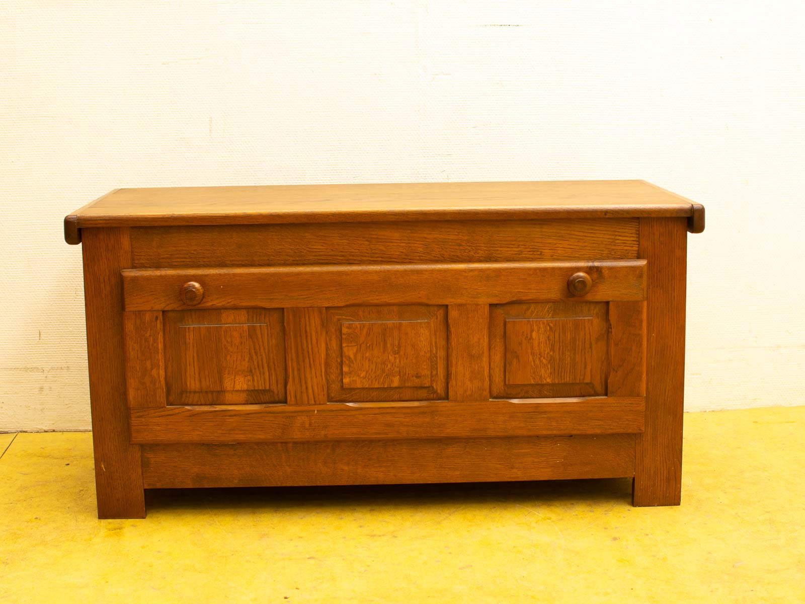 Rustic vintage wooden chest with elegant panels and practical drawer, perfect for storage and decor.