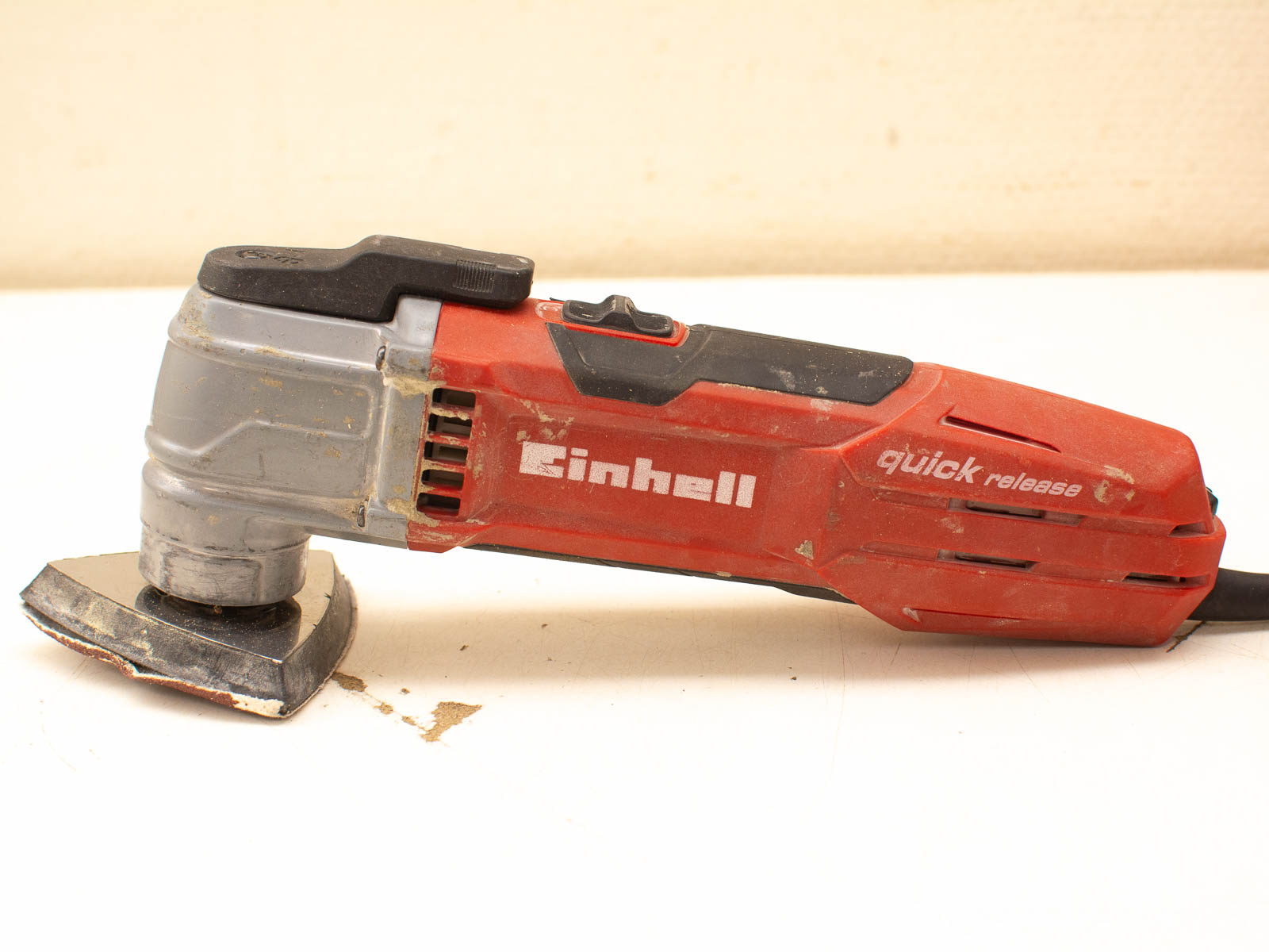 Versatile Einhell oscillating multi-tool in red, perfect for cutting, sanding, and DIY projects.