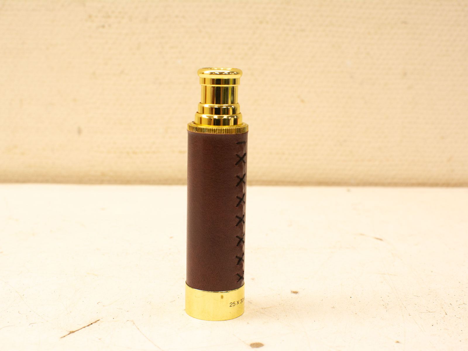 Sophisticated leather cylindrical device with gold accents, perfect for style and functionality.