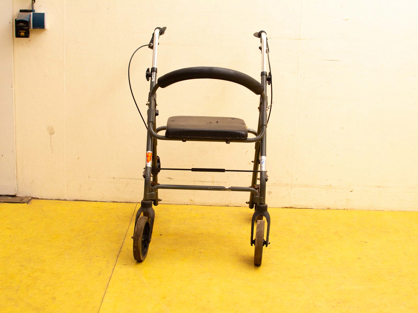 Ergonomic gray vintage mobility walker with padded seat for comfort and stability during use.