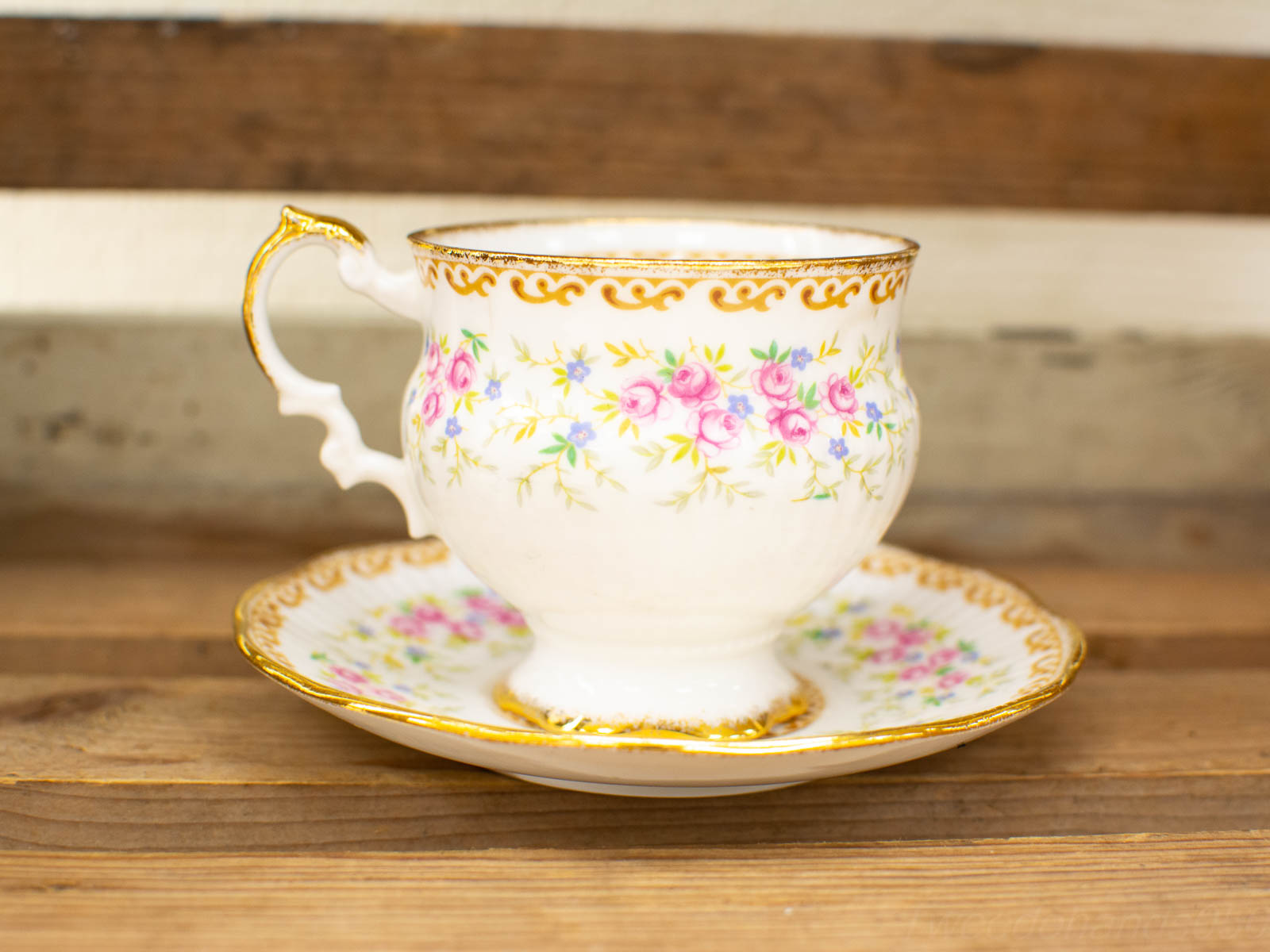 Elegant vintage porcelain teacup and saucer with floral design and gold accents. Perfect for tea.