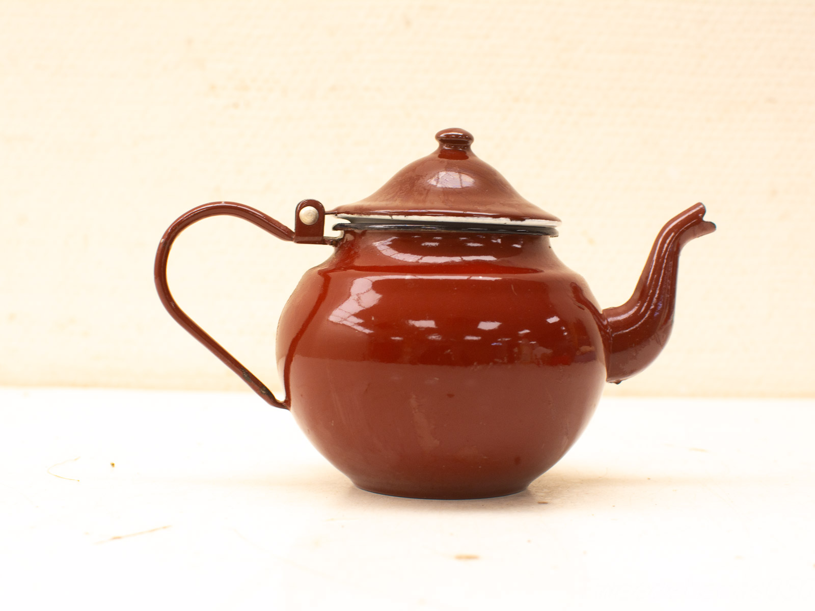 Vintage reddish-brown teapot with classic design, adding warmth and style to tea time.