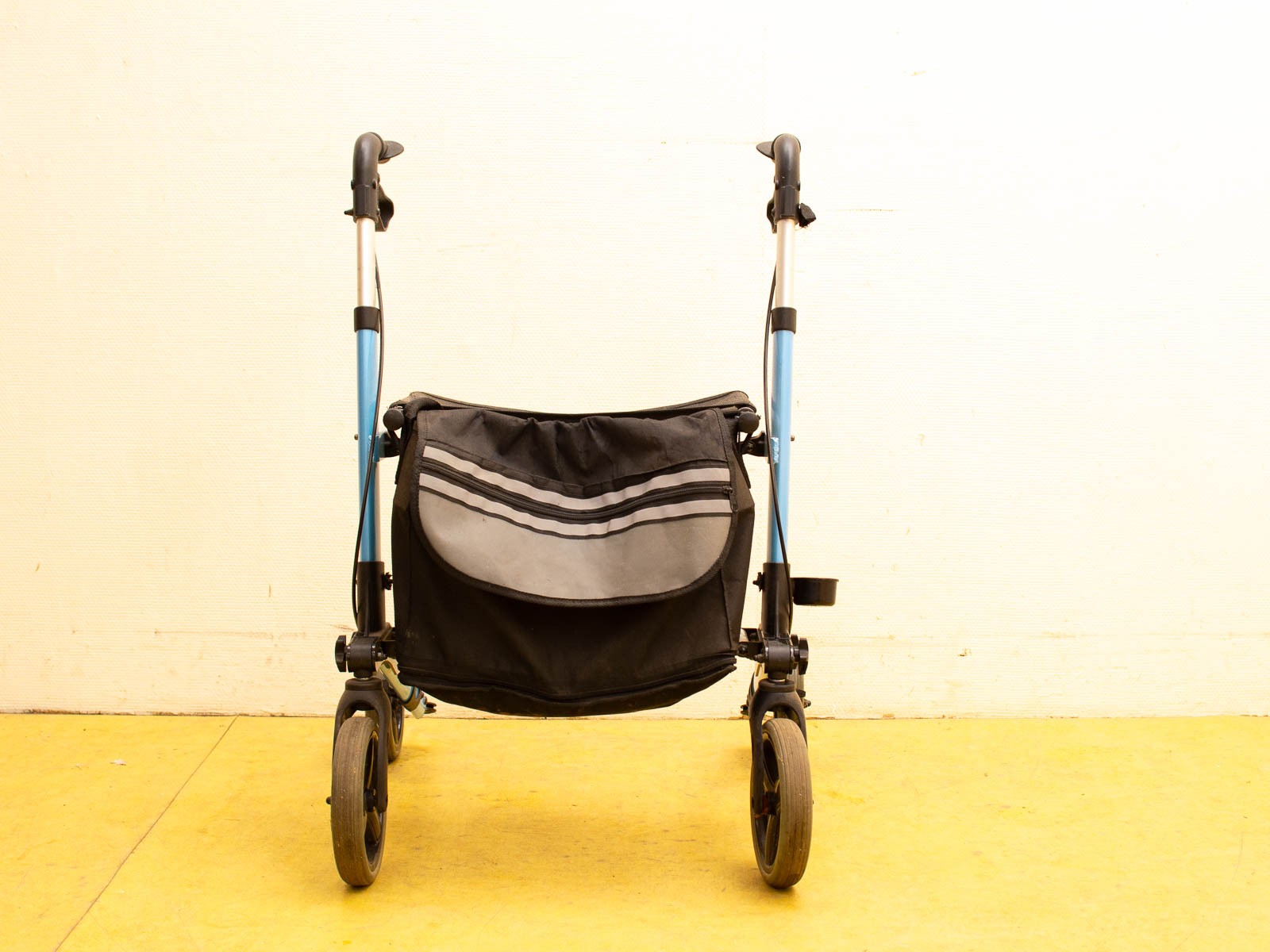 Lightweight blue walker with seat and storage pocket for enhanced mobility and comfort.