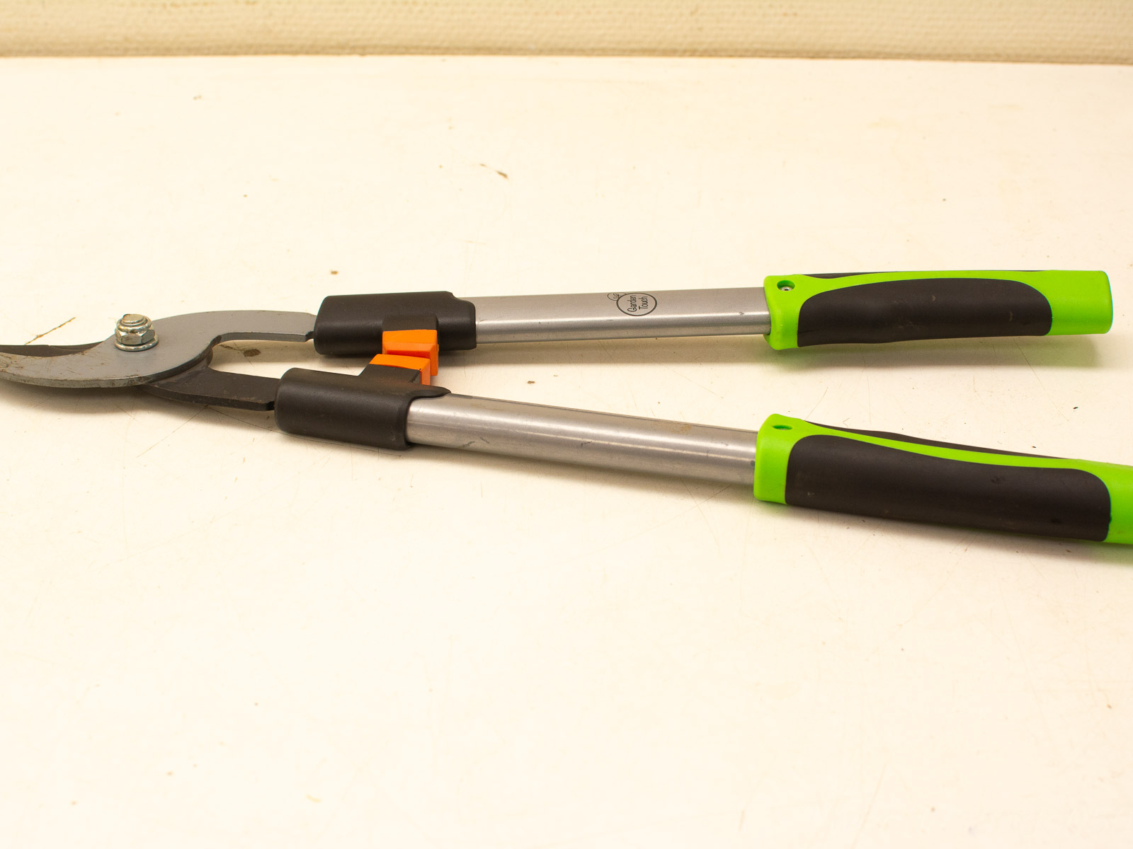 Quality second-hand loppers with green handles, sharp blades, and a safety lock for effective pruning.