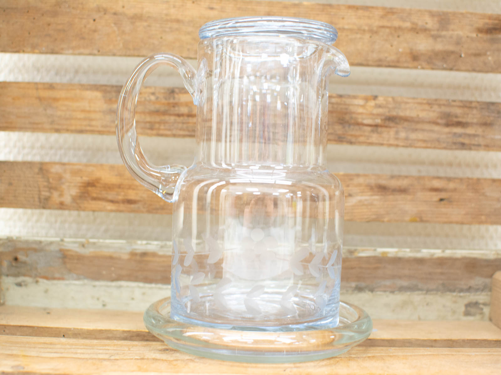 Elegant glass pitcher with etched floral designs, perfect for enhancing your table decor.