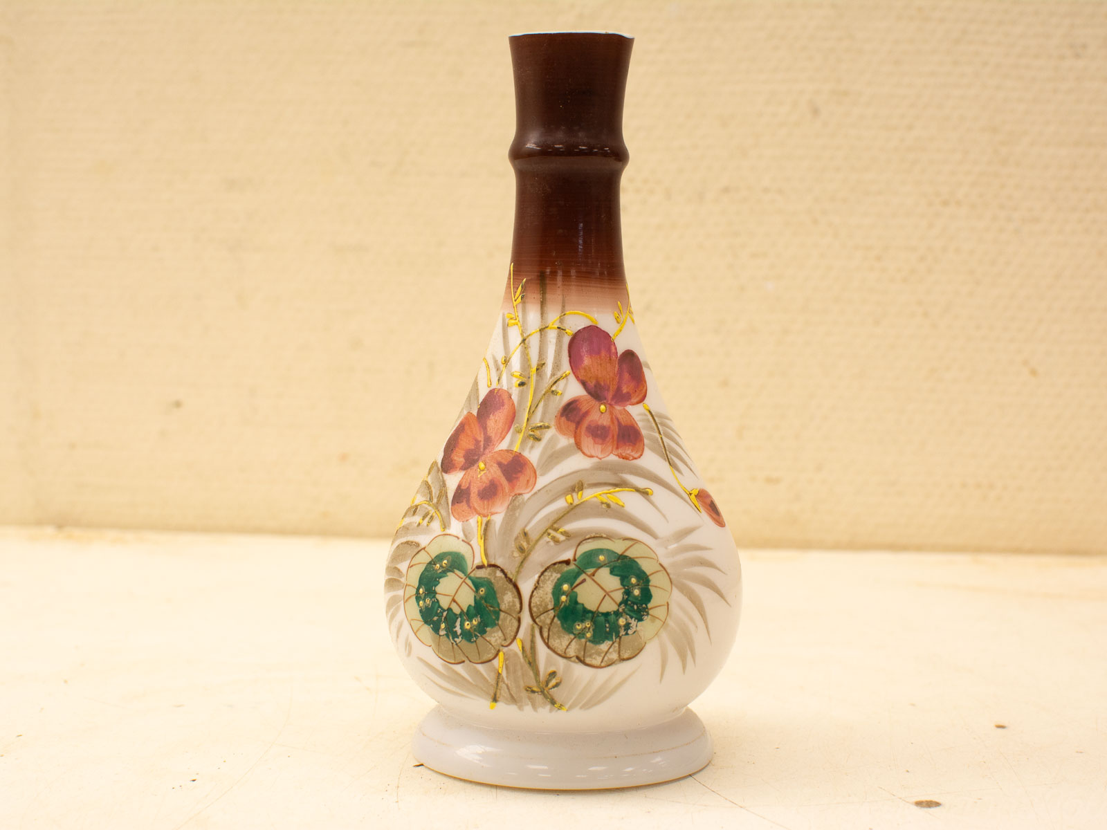 Elegant porcelain vase with intricate floral design and gold accents, perfect for home or gallery decor.