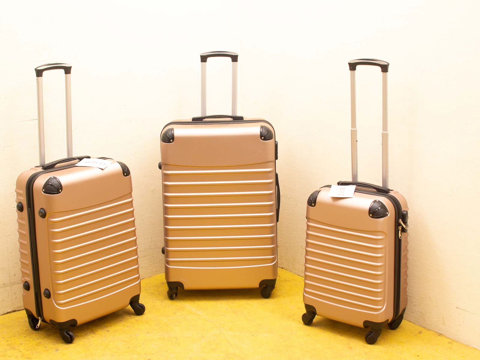 Stylish metallic gold suitcases with ribbed texture, perfect for your next adventure.