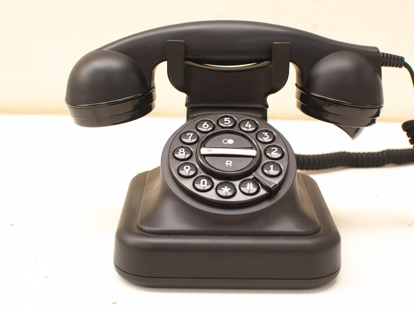 Classic 1960s black rotary telephone, a timeless symbol of vintage communication technology.