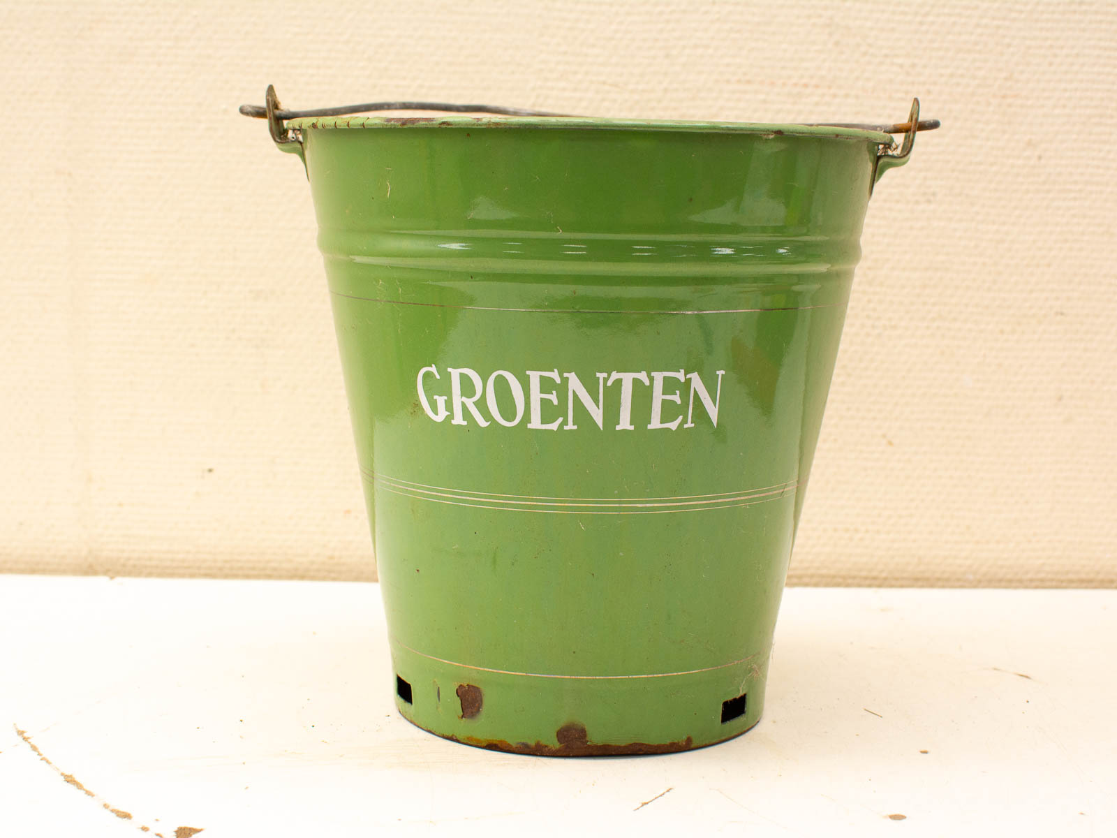 Vintage green metal bucket for vegetables, featuring charming rustic details and a glossy finish.