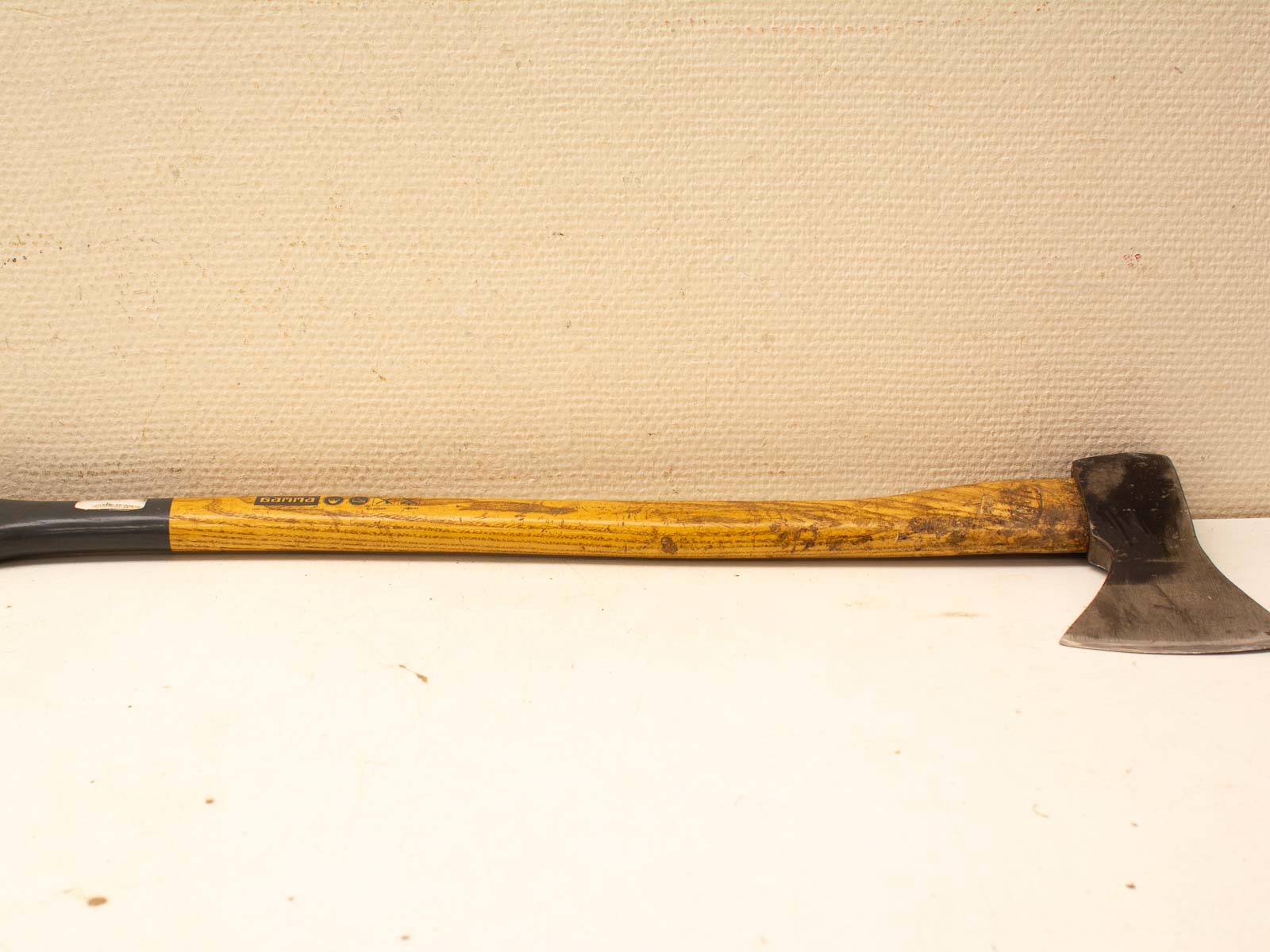 Vintage wooden and metal axe with wear, designed for chopping and crafted for functionality.