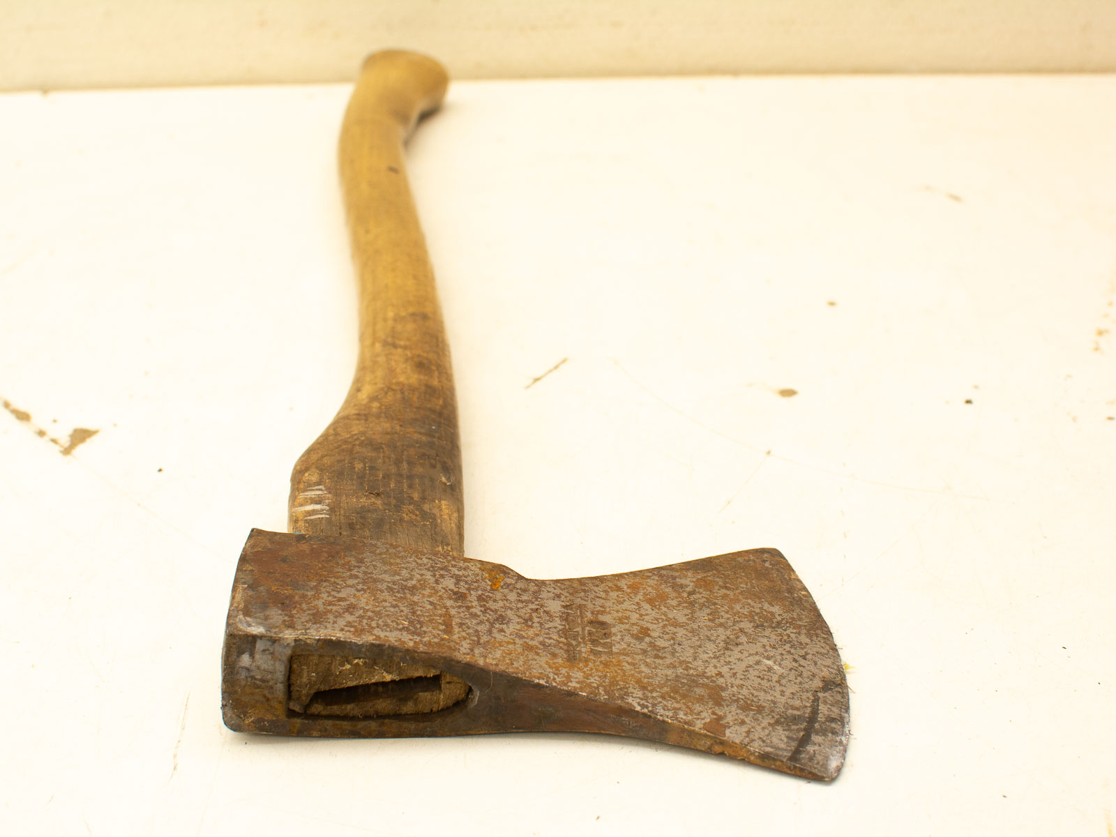 Vintage axe with a rustic wooden handle, showcasing history and unique charm for collectors.