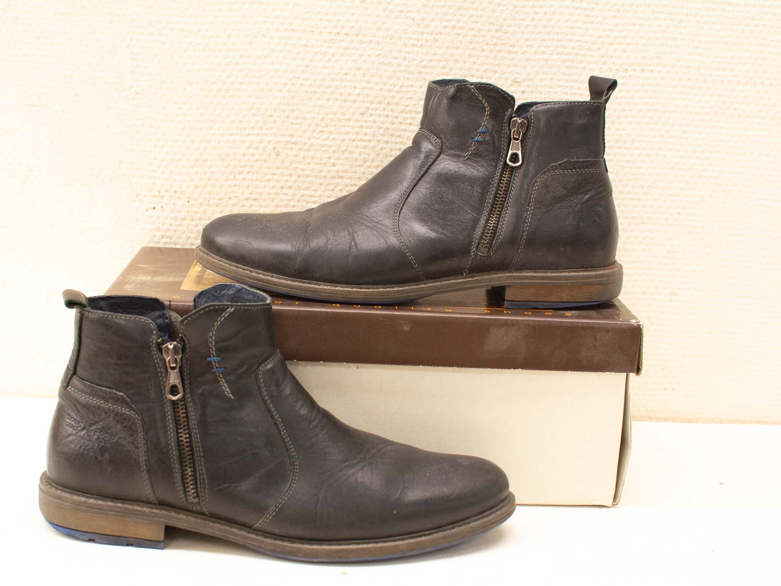 Stylish second-hand dark brown leather ankle boots with zippers and a comfortable sole.