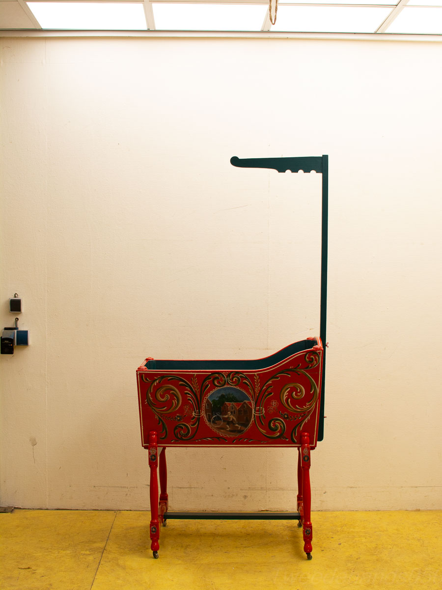 Vibrant red vintage cart with intricate details, perfect for home decor and display.