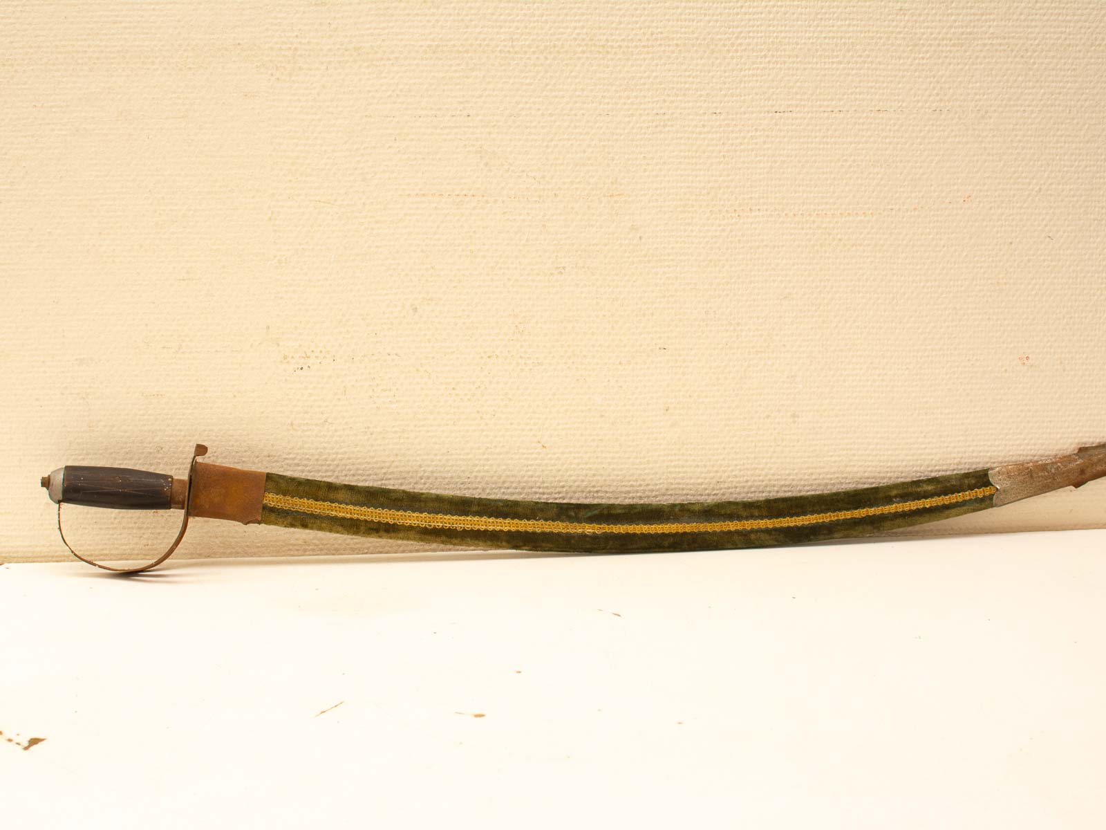 Elegant historical sword with ornate green and yellow scabbard, showcasing exceptional craftsmanship and design.