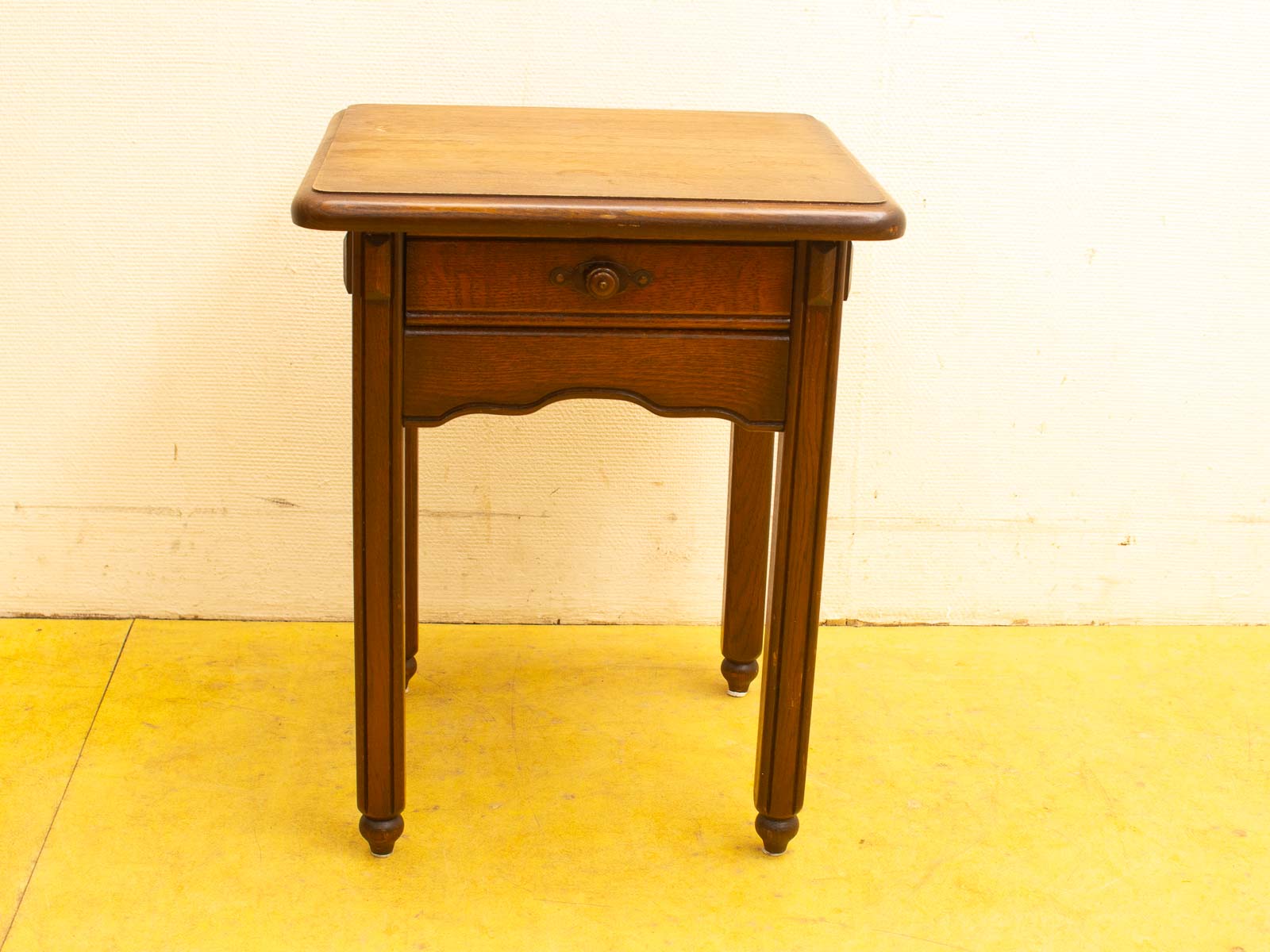 Elegant vintage wooden side table with storage drawer, featuring refined craftsmanship and dual-tone finish.