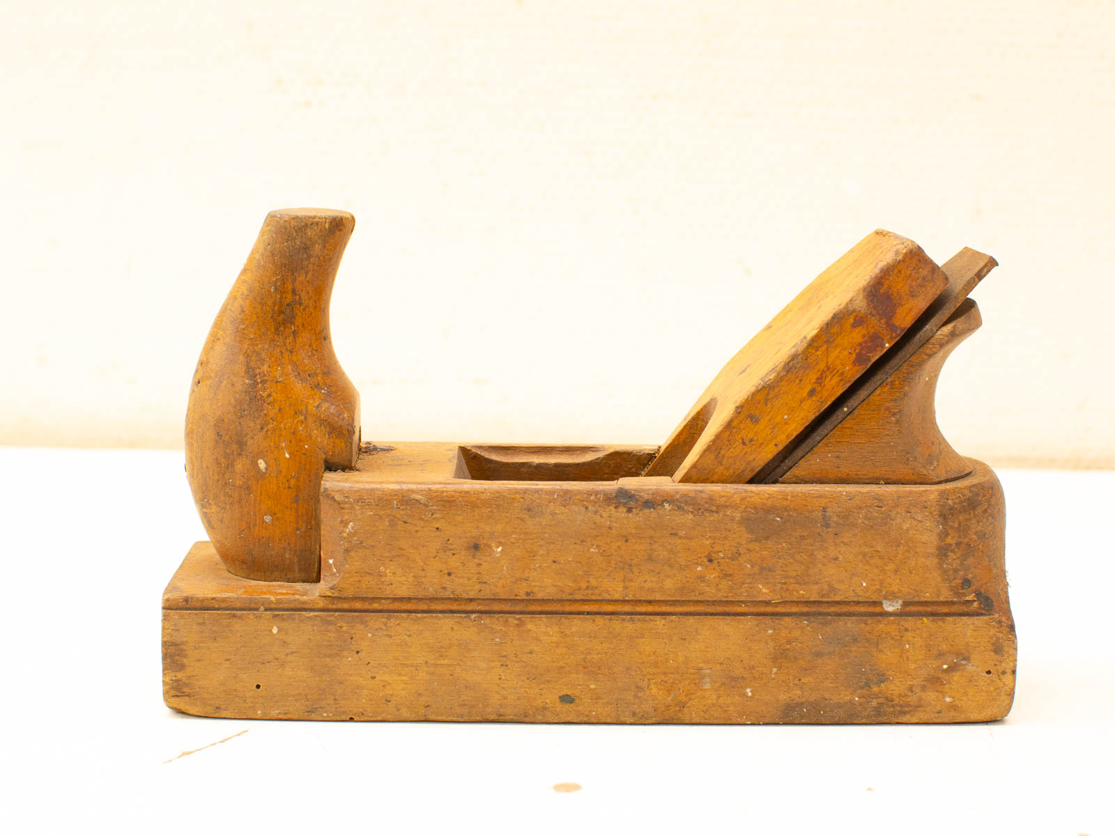 Vintage wooden hand plane showcasing craftsmanship, rich grain, and functional design for woodworking enthusiasts.