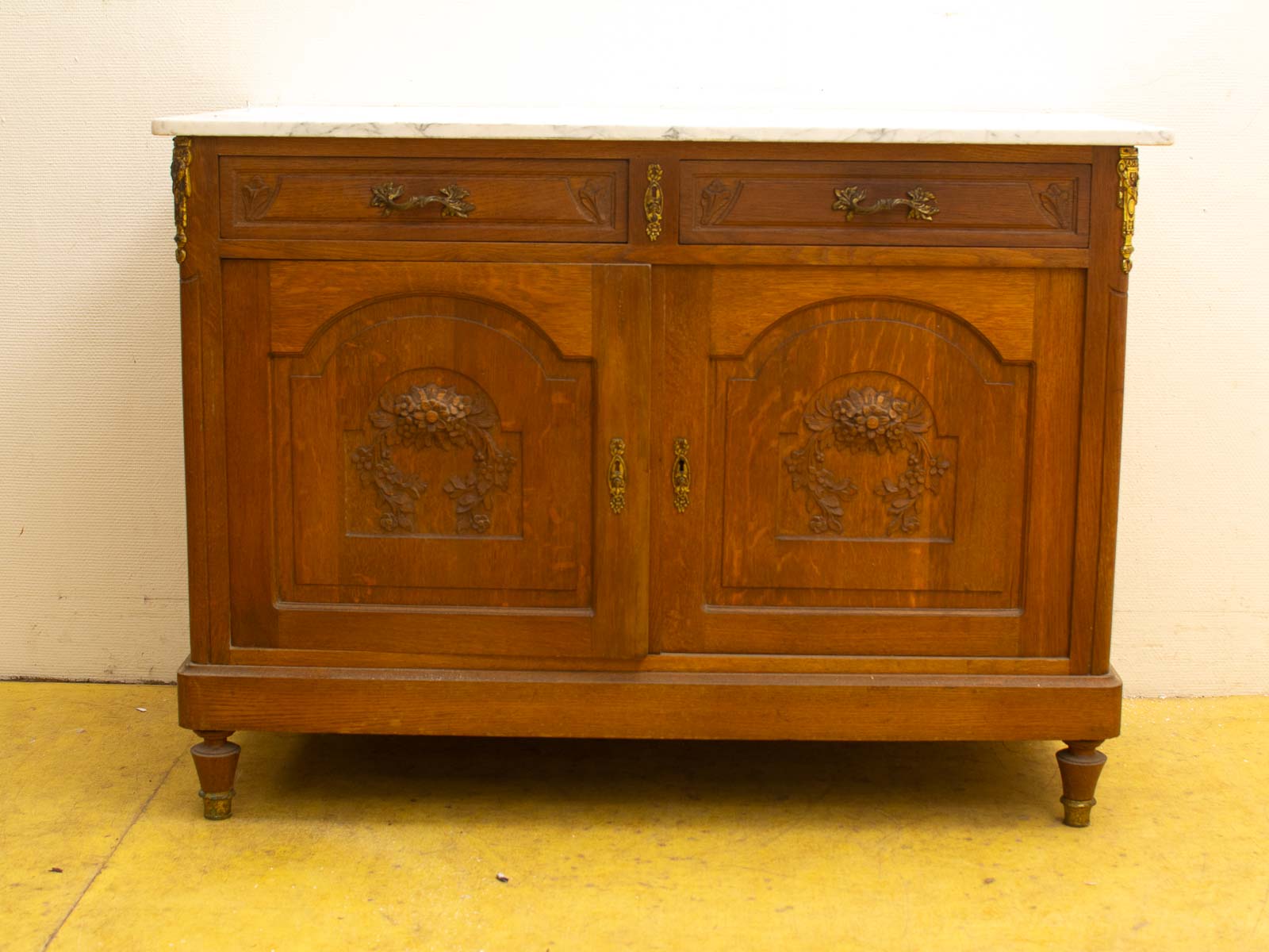 Elegant vintage wooden cabinet with marble top and intricate floral carvings, perfect for any decor.