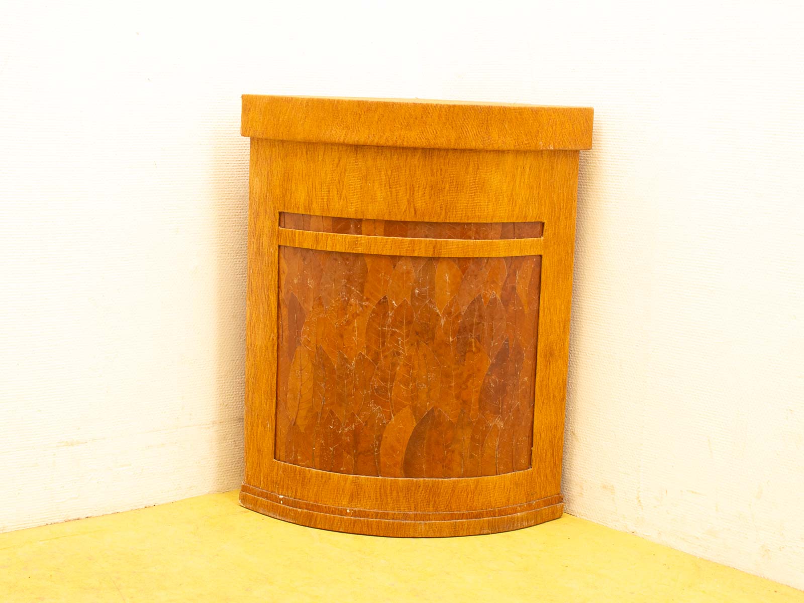 Elegant wooden trash bin with nature motifs, polished finish, and stylish rounded design for any decor.