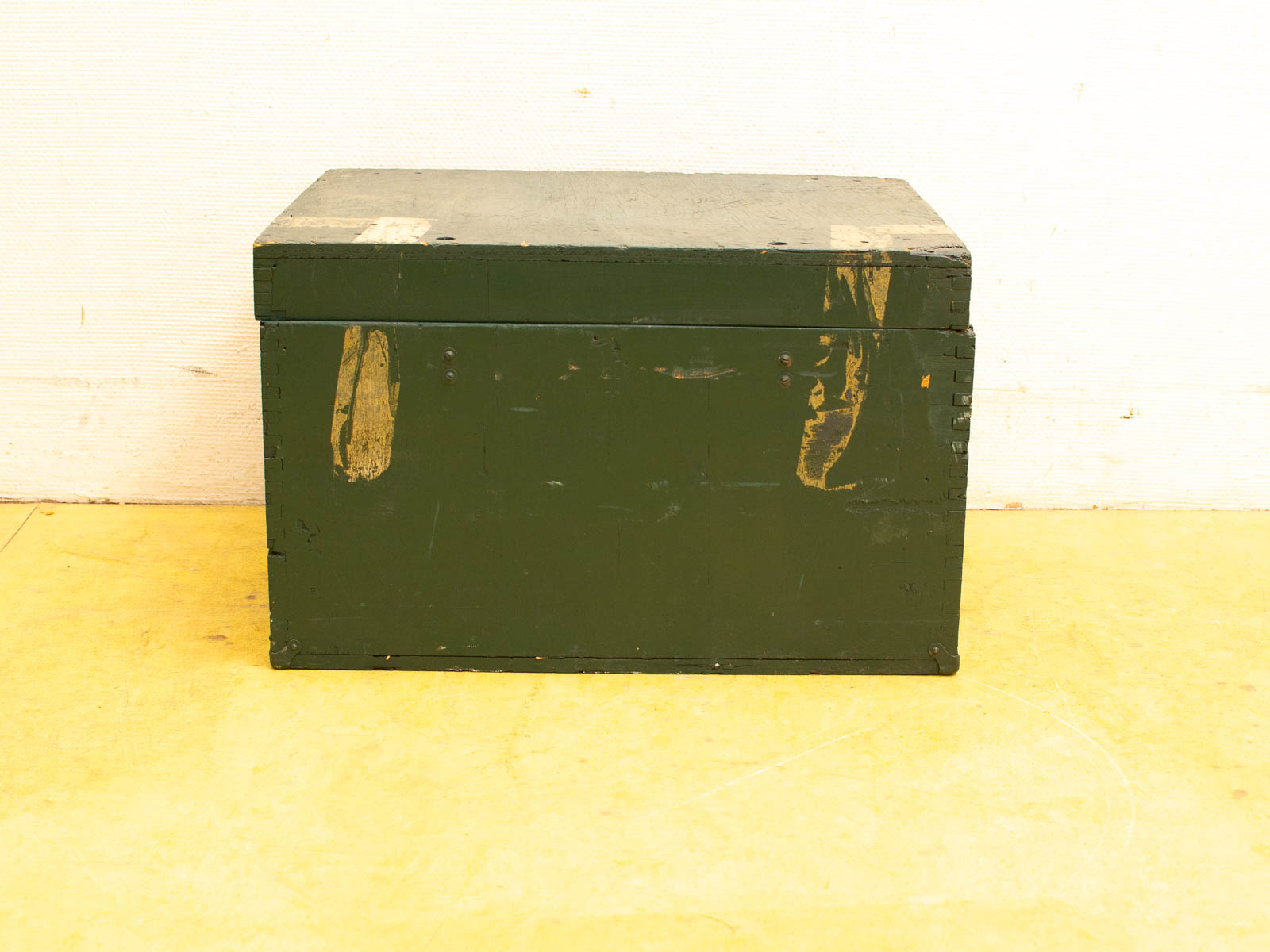 Weathered green wooden box with character, perfect for rustic storage and vintage decor.