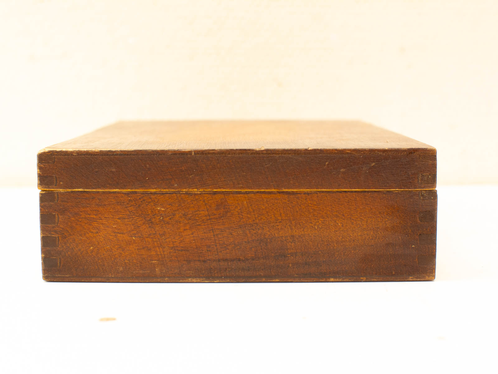 Handcrafted dark wooden storage box with quality dovetail joint, showcasing natural elegance and vintage charm.