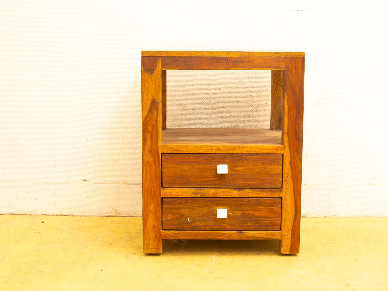 Stylish wooden nightstand with open shelf and drawers, blending modern simplicity and timeless elegance.